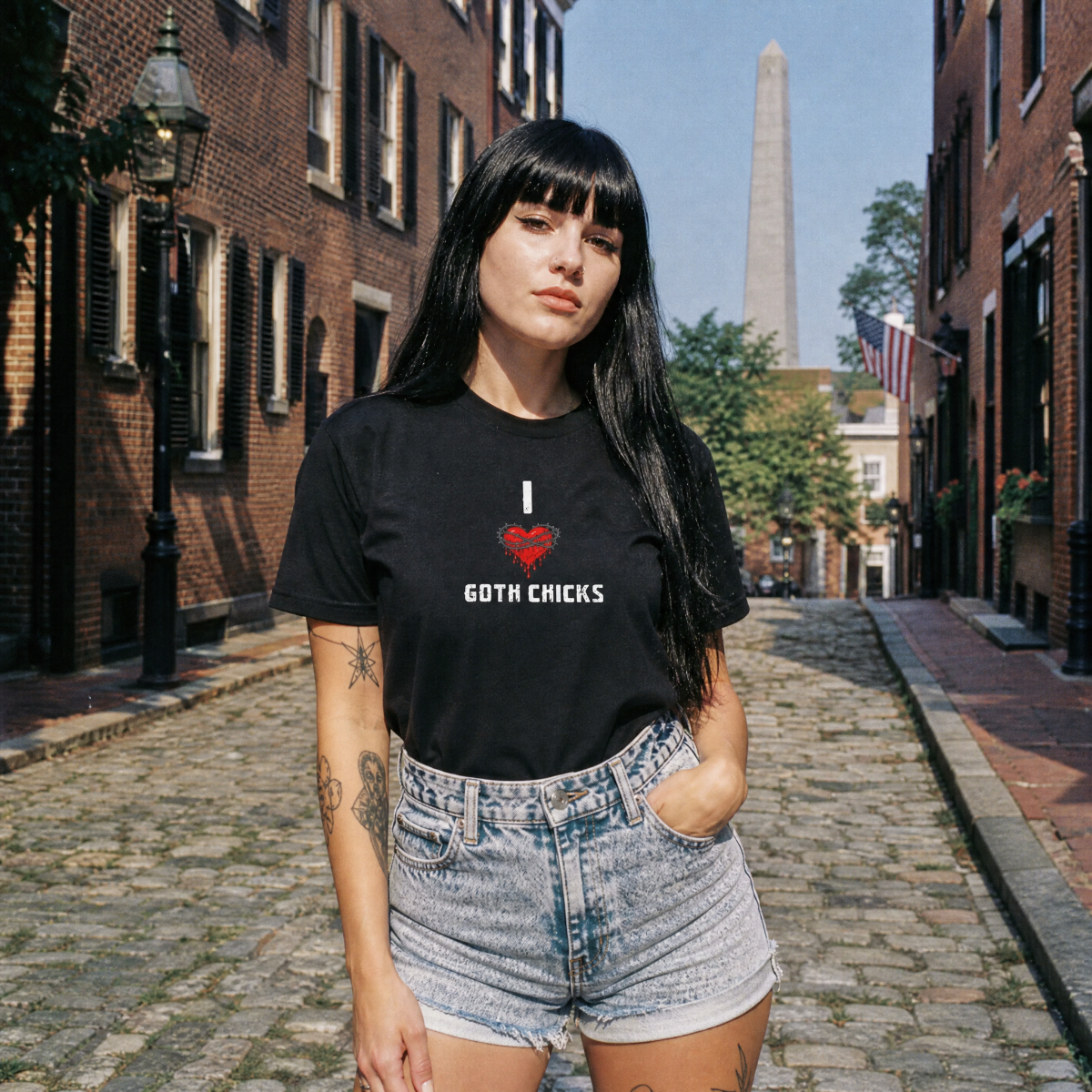 Mayhem Haus I Love Goth Chicks T-Shirt on a model in a cobblestone street
