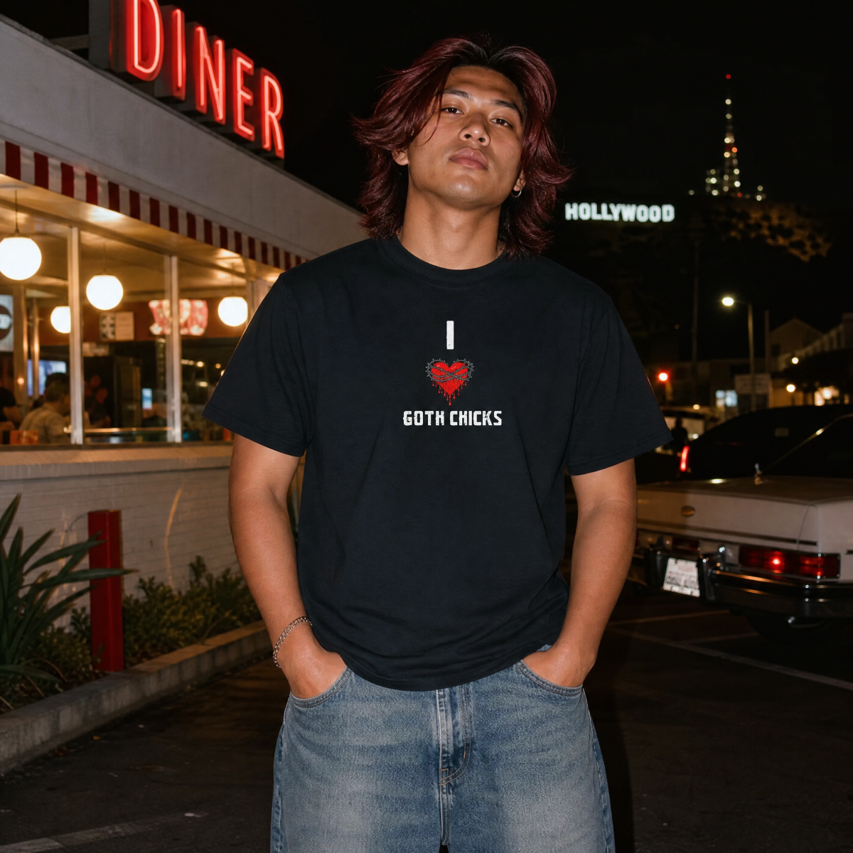 Mayhem Haus I Love Goth Chicks T-Shirt on a person at night with a diner and Hollywood sign
