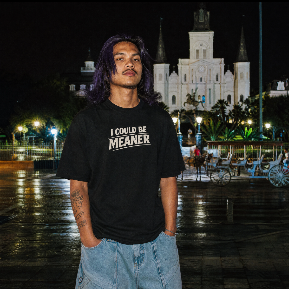 Mayhem Haus I Could Be Meaner T-Shirt on a person with purple hair at night