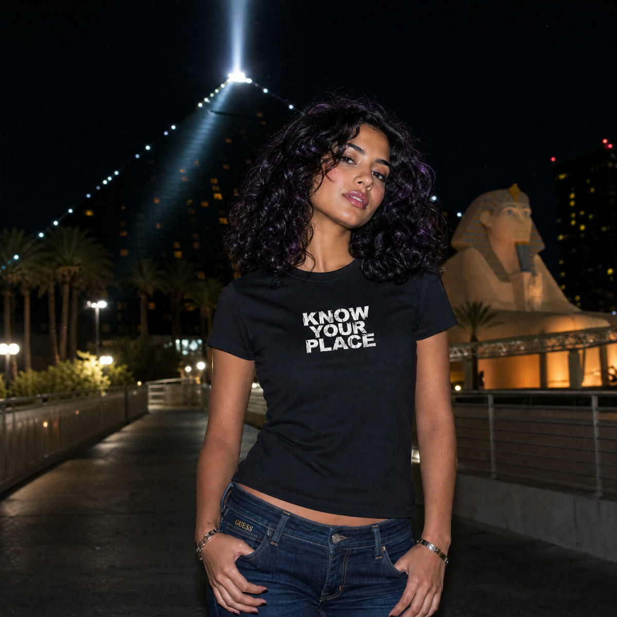 Mayhem Haus Know Your Place T-Shirt on a model at night with a pyramid and sphinx in the background