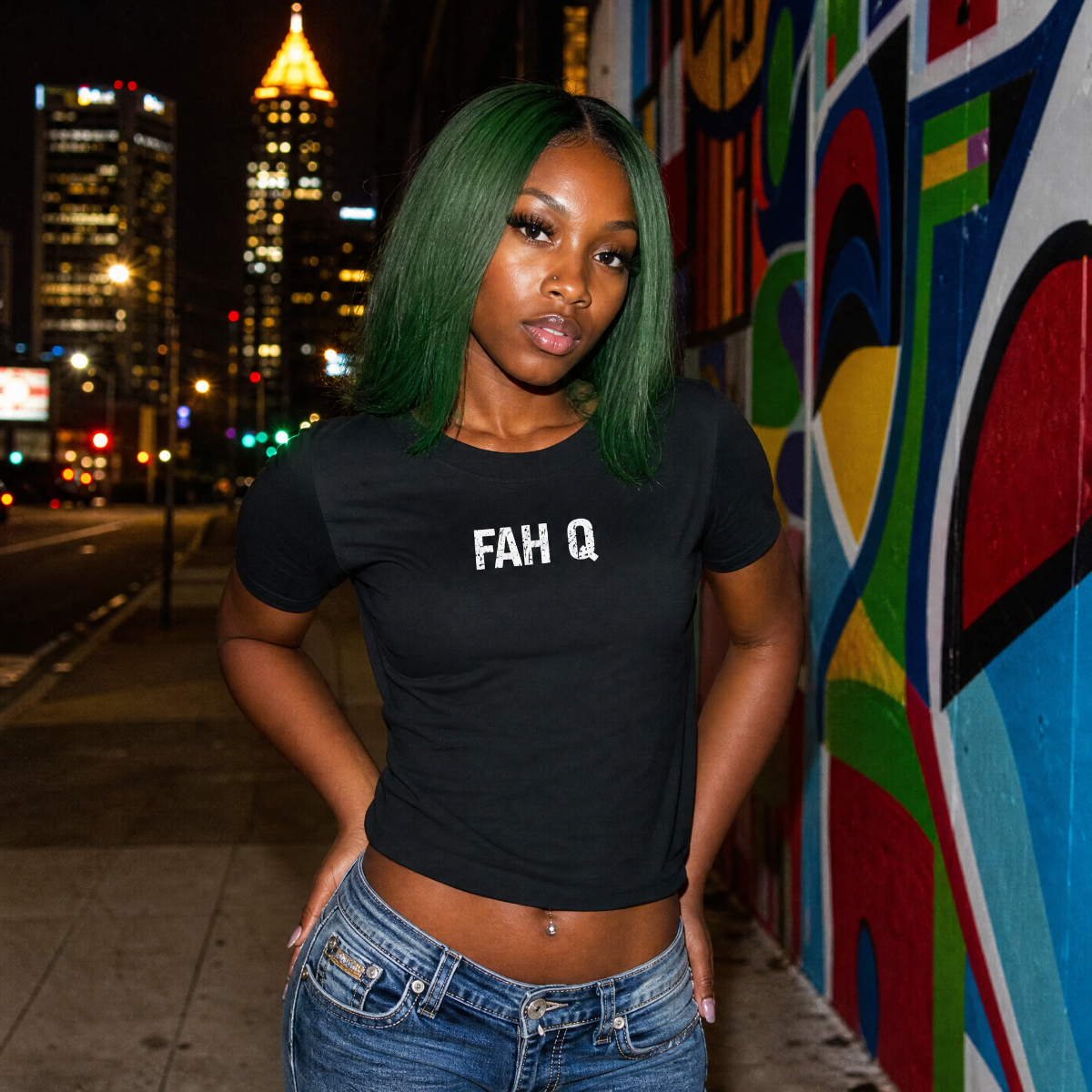 Mayhem Haus FAH Q T-Shirt on a model with green hair, city lights in background