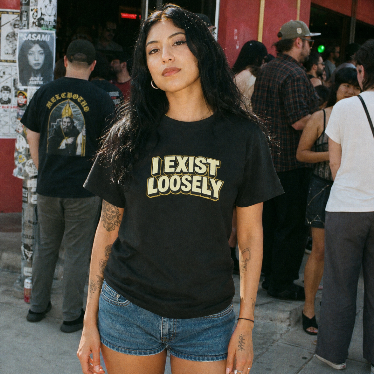 Mayhem Haus I Exist Loosely T-Shirt in black on a model with long dark hair and denim shorts