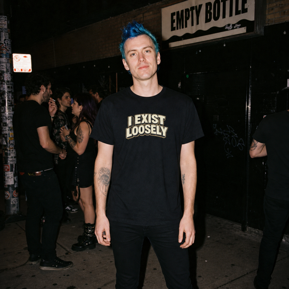 Mayhem Haus I Exist Loosely T-Shirt on a person with blue hair, standing outside at night