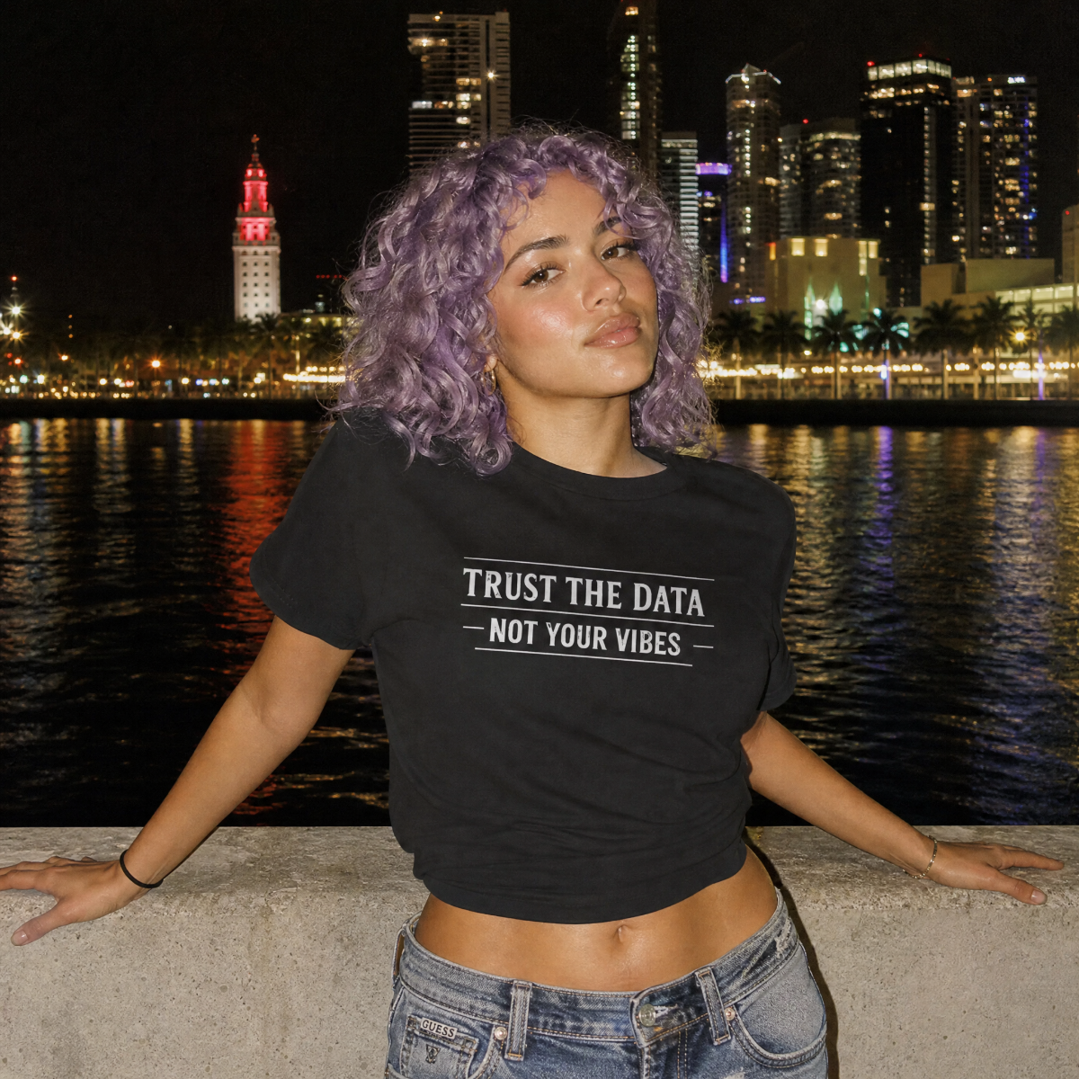 Mayhem Haus Trust the Data, Not Your Vibes T-Shirt on a person with purple hair at night